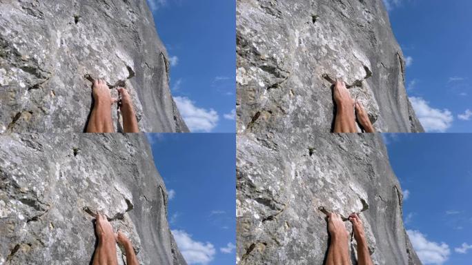 登山者抓住岩石表面的缝隙