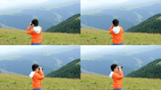 亚洲男孩在草原上用望远镜看风景
