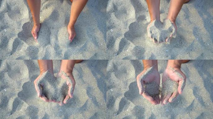 双手在海滩上握着和洒沙