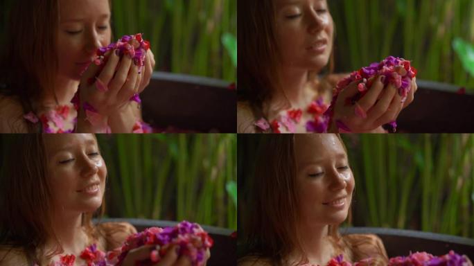 一个美丽的年轻女子在热带水疗中心洗花浴的慢镜头