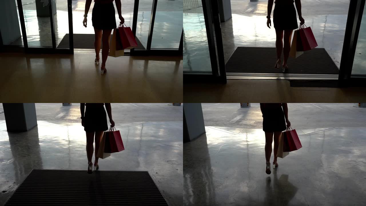 用购物袋走路的女性腿的慢动作
