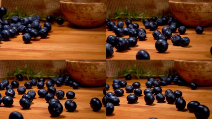 令人垂涎的蓝莓在木质表面滚动