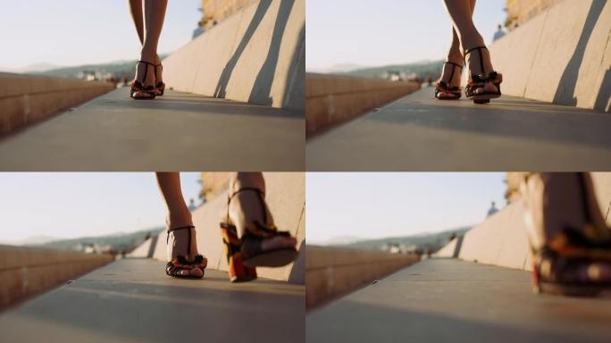 穿着高跟鞋的女性腿在城市街道上行走。