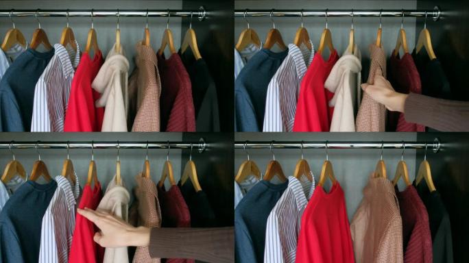 女人从家里的衣柜里拿衣服