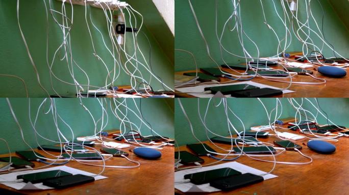 许多智能手机和手机在桌子上充电