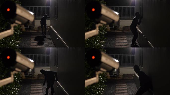 闭路电视监控摄像头抓拍现场小偷跳下来夜间试图闯入一户人家