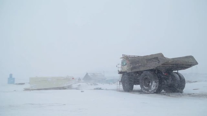 一辆自卸车站在冬季煤矿上