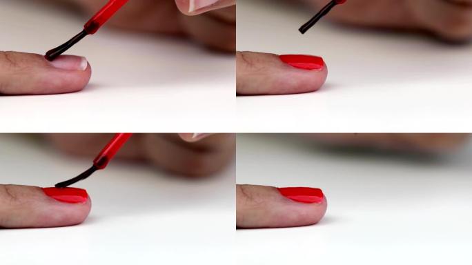 妇女在手指上涂抹红色指甲油
