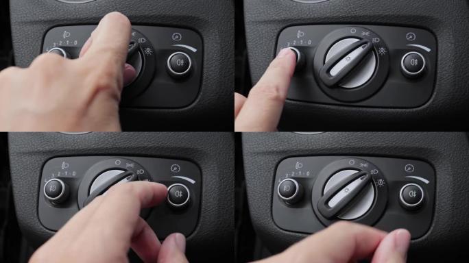 一只手打开现代汽车的前灯和雾灯，前照灯按钮的细节，灯旋钮