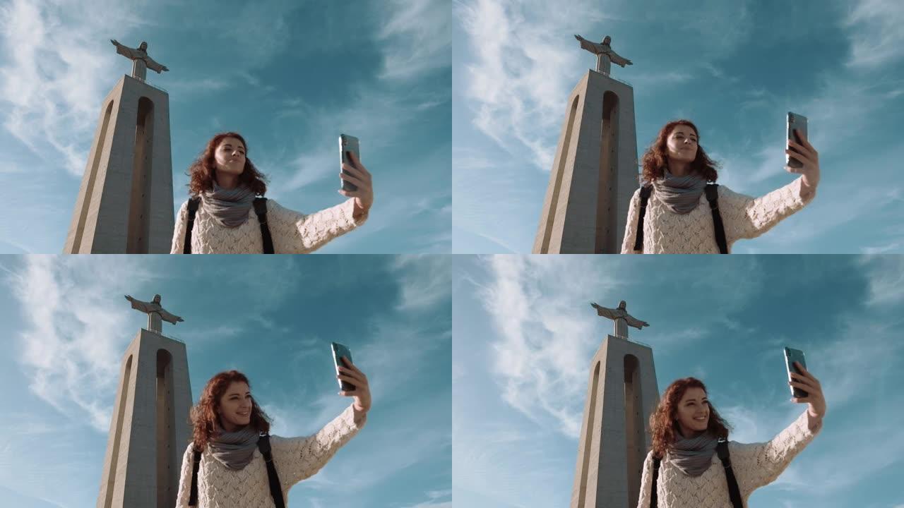 葡萄牙，里斯本和基督雕像。女孩在基督像附近拍下了自己的照片。