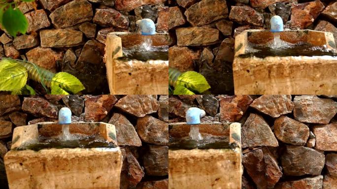 喷泉和石头砖墙中的流动水
