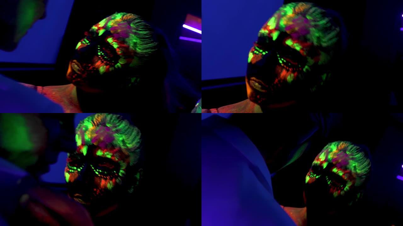 两个女孩用荧光化妆，紫外线人体艺术设计，彩绘五颜六色的面孔