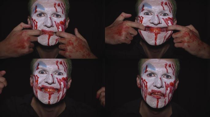小丑万圣节男子肖像。令人毛骨悚然，邪恶的小丑血脸。白脸妆