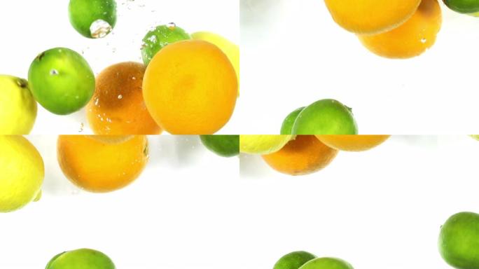 柑橘类水果落入水中。橙子，酸橙和柠檬落入水中