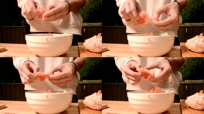 手的特写家庭厨房里的一个女孩打扫和排骨葡萄柚做素食沙拉