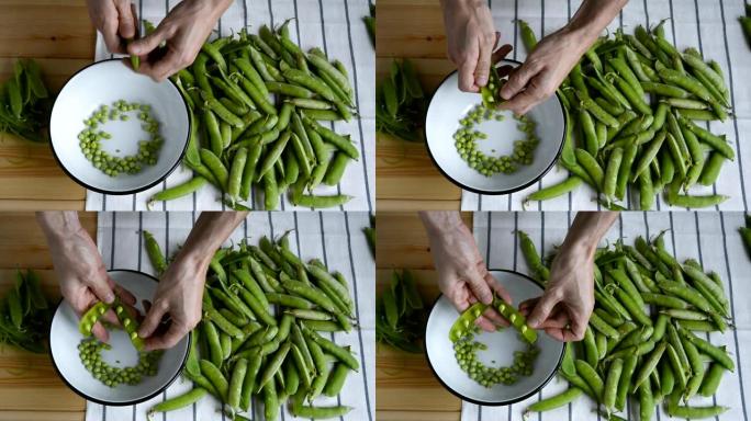 男人用手去壳新鲜成熟的绿豌豆豆