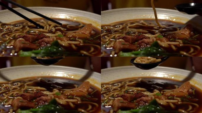 女人用棍子吃牛肉面的慢动作。中式餐厅