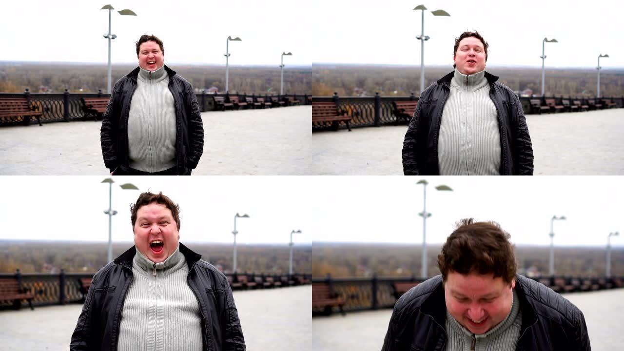 从特写镜头放大，快乐胖子的肖像直接看着相机并大笑