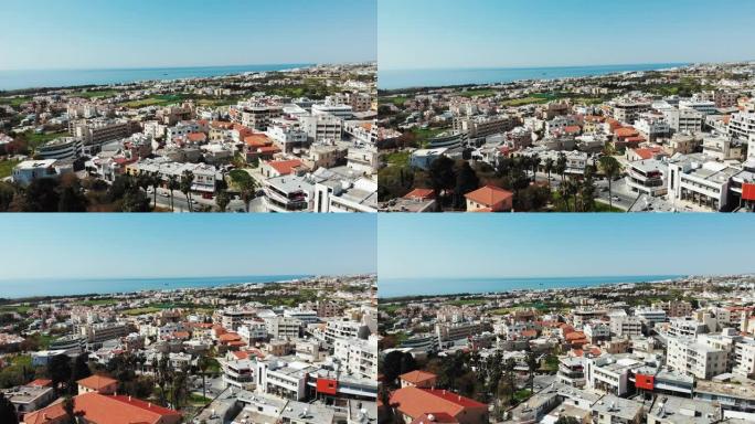 航拍的帕福斯城在塞浦路斯与建筑和商业中心，以海为背景。阳光明媚的夏天