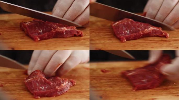 4k亚洲男子手工切片红色生牛肉牛排，在木质切片板上，日光，锋利的小刀，黑色围裙，厨师在烹饪前准备肉，