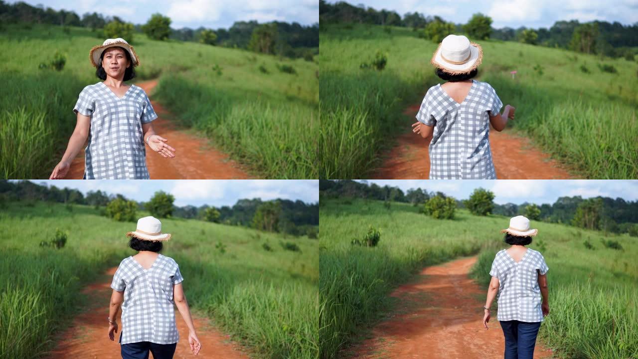 泰国考艾国家公园的草地上美丽的女人玩旋转