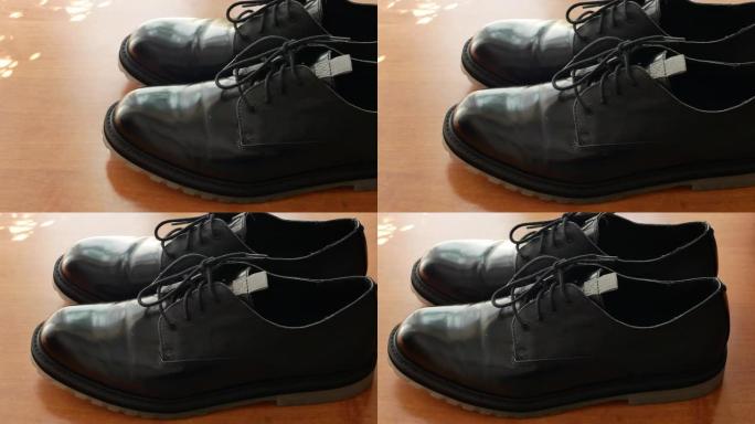 木制书桌上的男士黑色礼服正式办公室皮鞋的水平全景4k视频片段