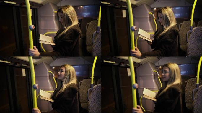 晚上乘公共汽车旅行的女乘客看书。女孩晚上在行驶中的汽车上读故事