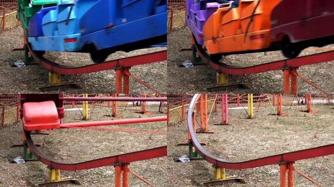 特写镜头春天，一个五颜六色的景点让人们在游乐园的铁轨上骑行。一个彩虹景点在露天兜风。