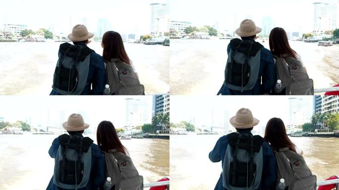 一对可爱的朋友在泰国曼谷湄南河乘船旅行。背包客戴着帽子观光首都城市旅行者暑假。