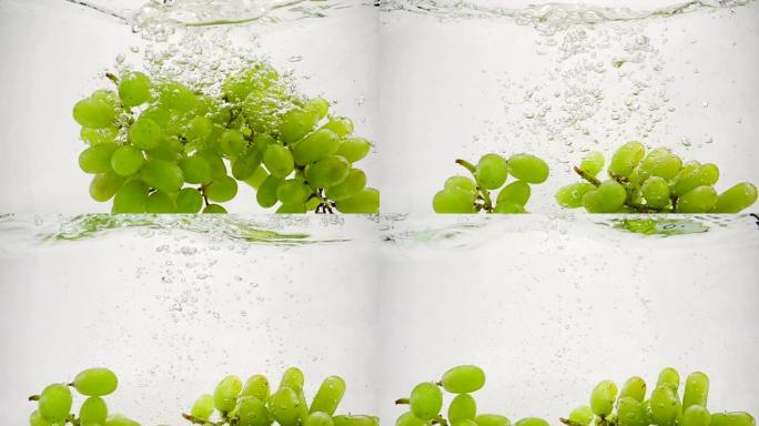绿色葡萄的慢动作视频。一束葡萄浸泡在带有气泡的水中。