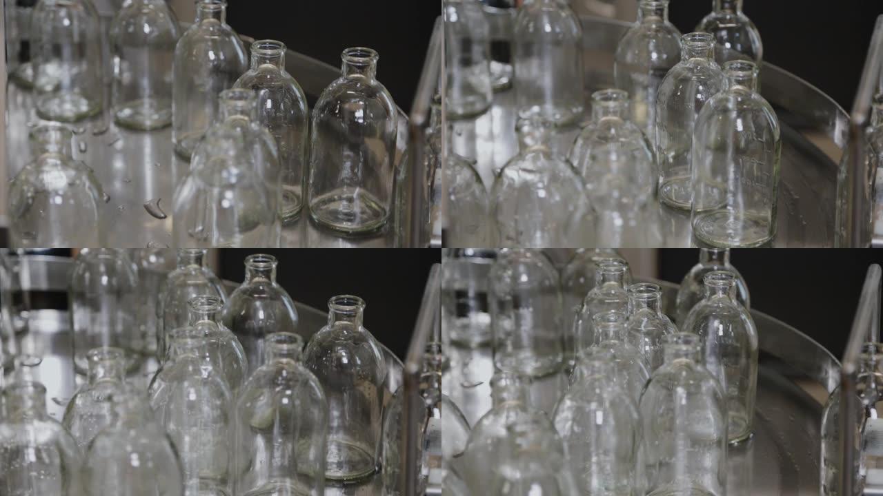 传送带上的玻璃无菌药瓶，用于填充内容物