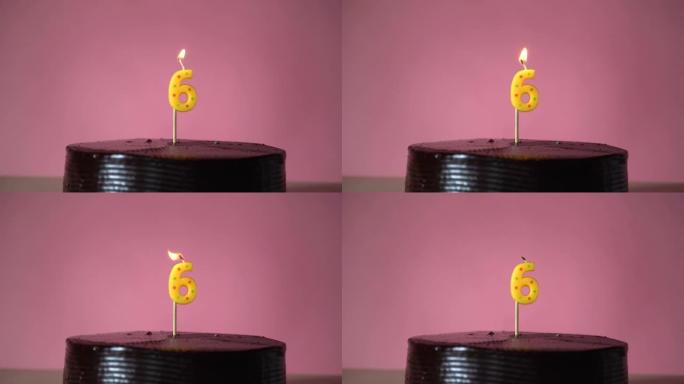 带有灯芯照明的巧克力生日蛋糕试图吹响蜡烛