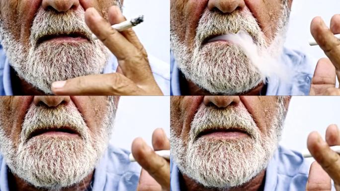 老人吸烟的特写镜头。