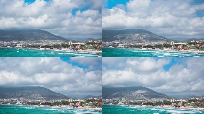 Sudak city by the mountains on the sea and clouds 