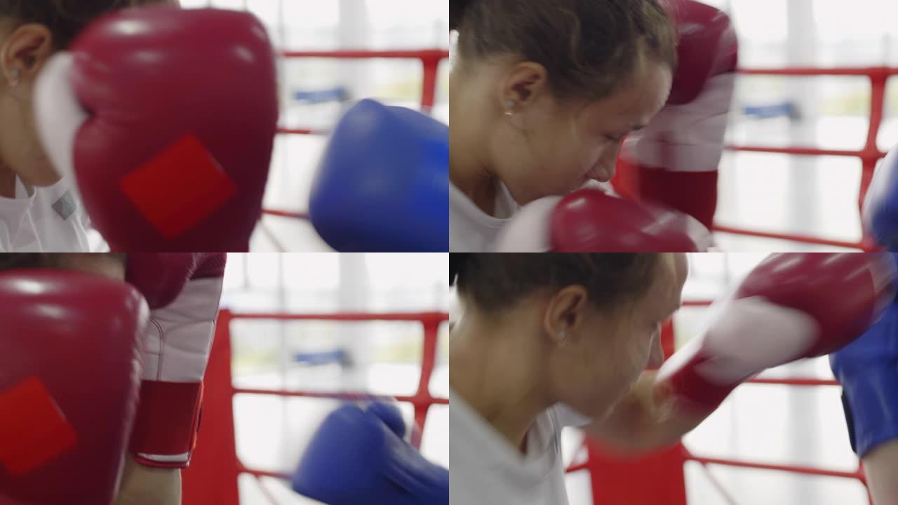 年轻的女拳击手在训练中戴着手套招架拳