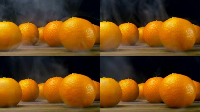 新鲜的橘子在冷的桌子上，慢动作从霜冻中蒸出来，特写