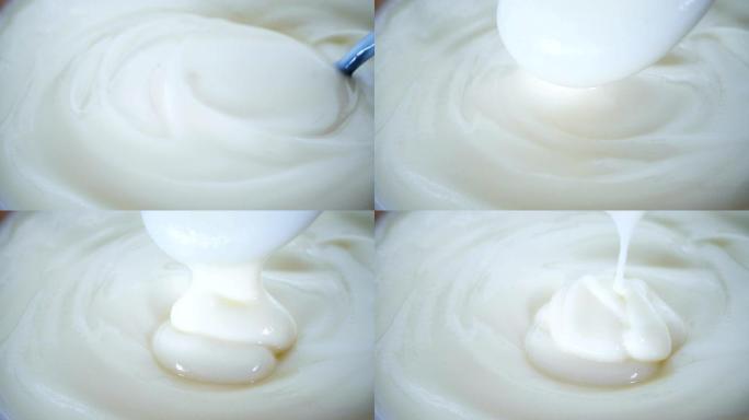 关闭发酵乳益生菌酸奶，健康食品，用勺子混合奶油凝乳