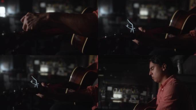 一个拉丁裔男子在昏暗的酒吧里演奏时，用原声吉他移动变调弹的特写镜头