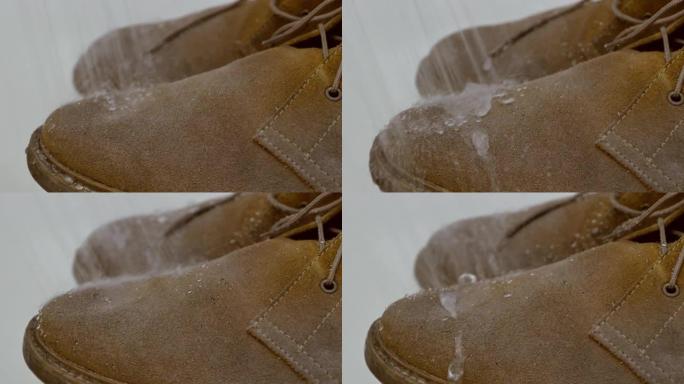 大雨概念下的防水麂皮靴子。水滚滚的鞋子，不要被表面吸收