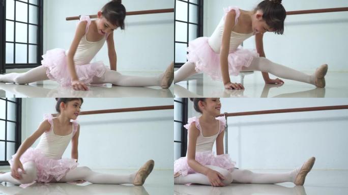 平移视图: 芭蕾舞女演员坐在那里伸展腿