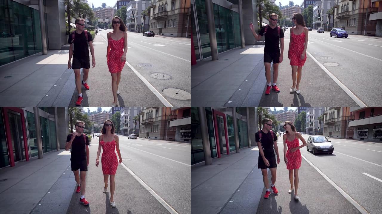 瑞士，卢加诺的城市景观。一对年轻人在城市里走来走去，红衣女孩，黑衣人