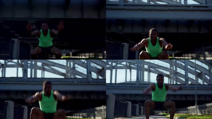 多莉拍摄了肌肉发达的非洲年轻运动员在城市桥上进行青蛙深蹲跳跃运动