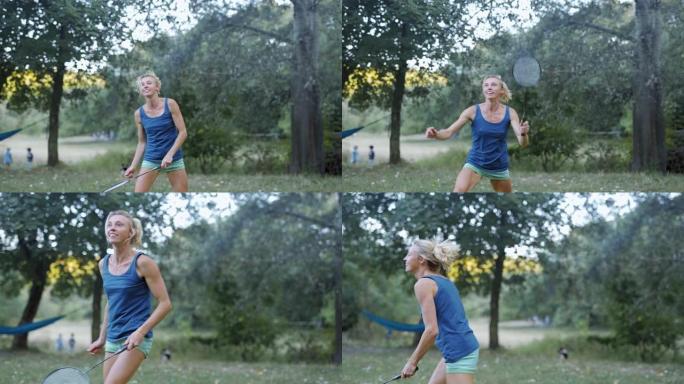 漂亮微笑的运动健身女子在公园打羽毛球