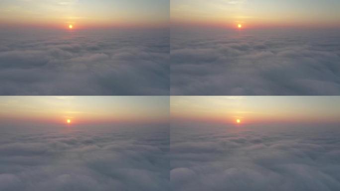 鸟瞰图。雾中飞，雾中飞。空中摄像机拍摄。从云层上飞向太阳。雾蒙蒙的天气，从上面看。鸟类的观点
