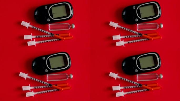 用于在红色背景上测量血糖的胰岛素注射器和血糖仪。