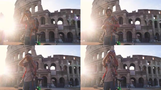 日出时，穿着衬衫和帽子的快乐年轻人游客在意大利罗马罗马斗兽场用老式相机拍照。