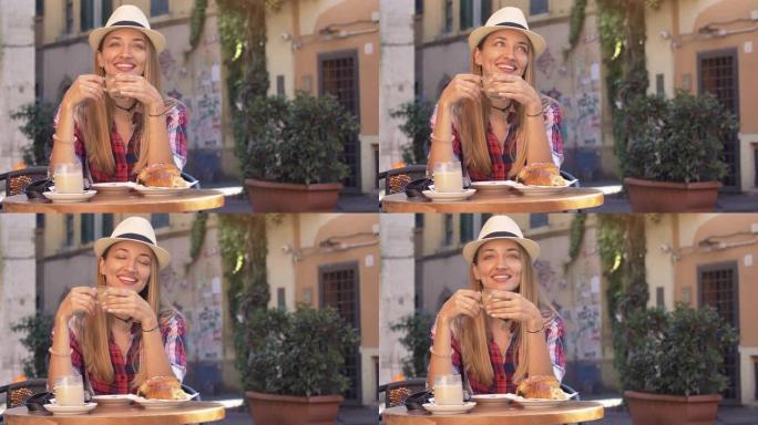 在意大利罗马的历史街区特拉斯特维里，一名金发碧眼的年轻女子正在典型的意大利酒吧里吃早餐。卡布奇诺，咖