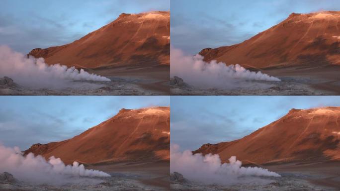 火热的火山。日出时的喷气孔。