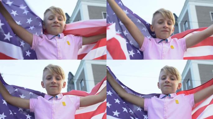 快乐的男孩举着美国国旗庆祝独立日，国家骄傲