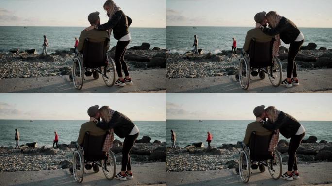女人在海边拥抱她心爱的残疾丈夫